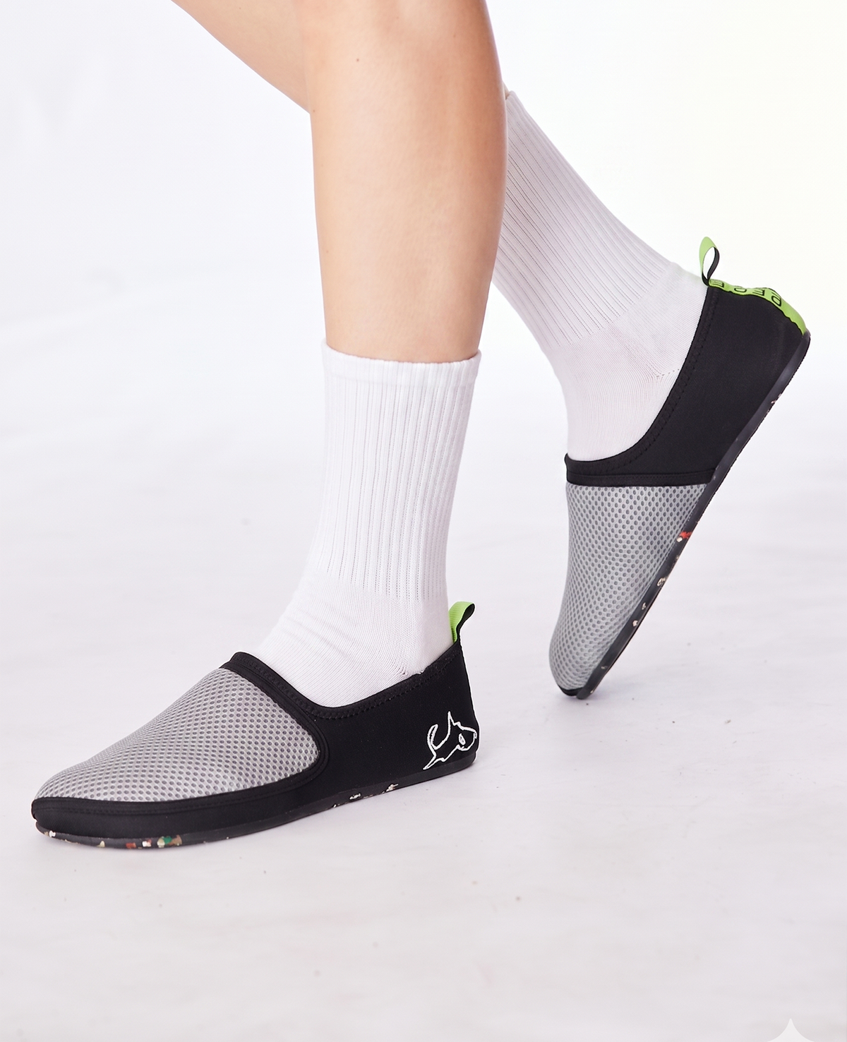 Lightweight grey and black slip-on shoes with mesh upper worn with white socks