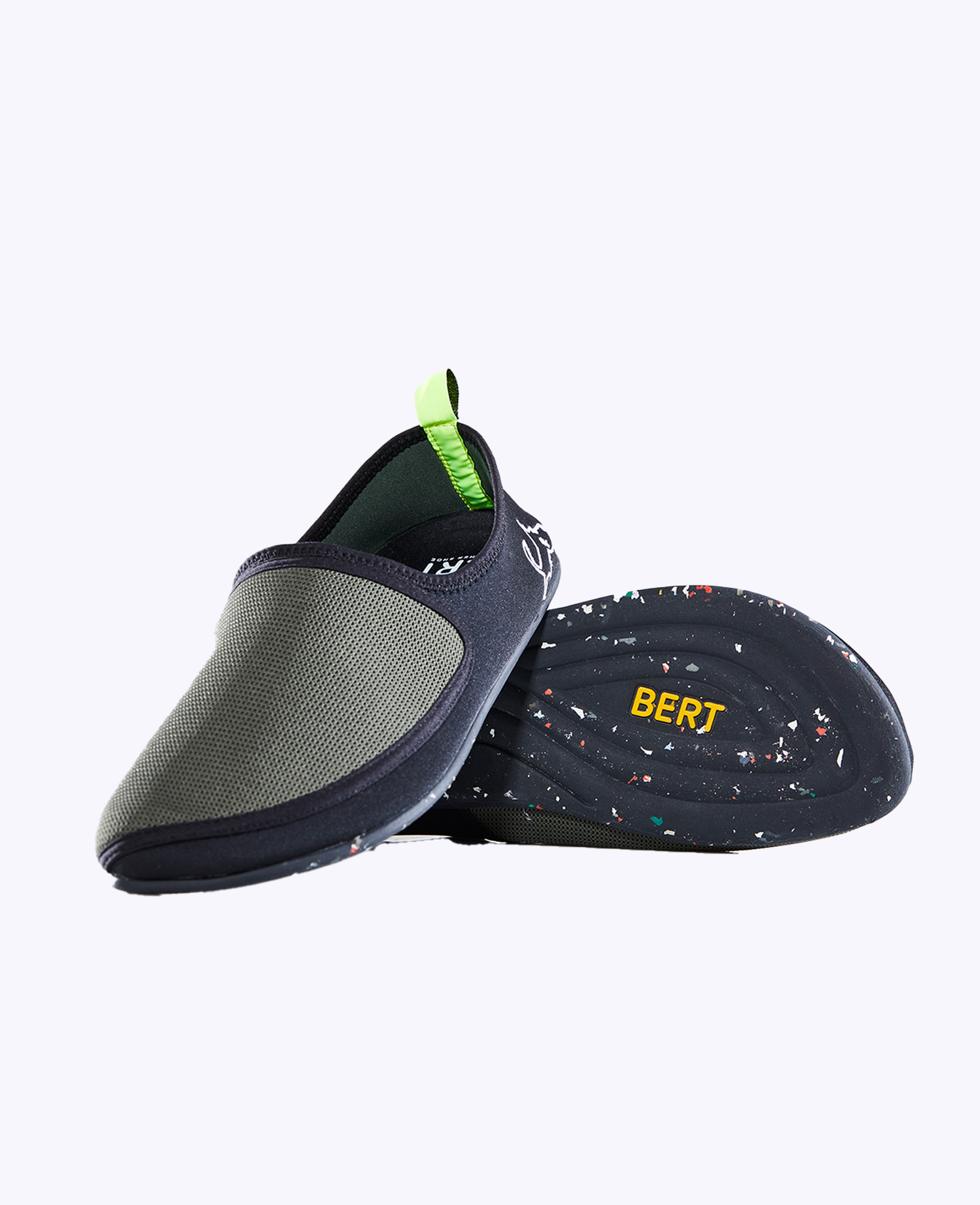 Olive green lightweight slip-on shoe with black sole and yellow BERT text, ideal for travel or casual wear.