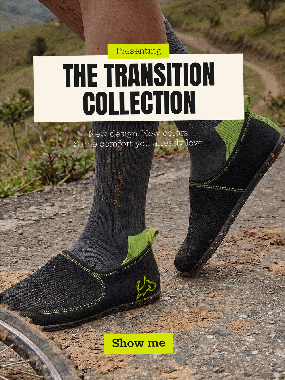 Lightweight black slip-on shoes with green accents worn outdoors on a dirt trail, promoting the Transition Collection.