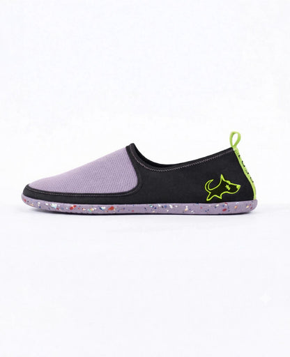Lightweight slip-on shoe in lavender and black with speckled sole and green accent details