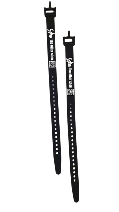 Two black adjustable silicone straps with holes, buckles, and 'The other shoe' text, shown on white background.
