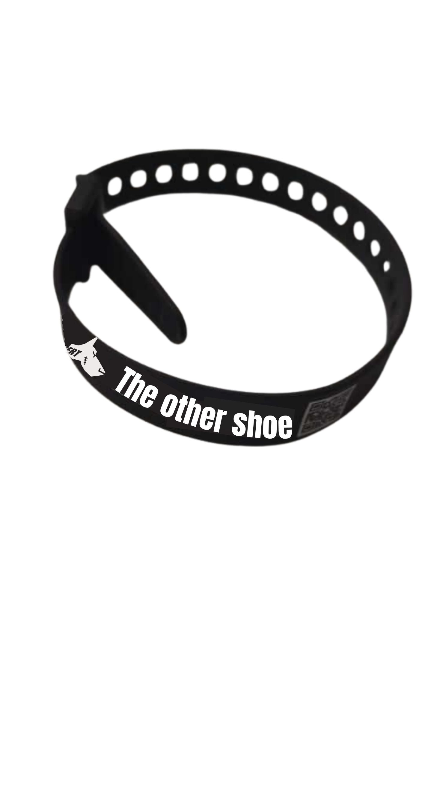 Black adjustable shoe strap with 'The other shoe' text, lightweight and minimalist design.