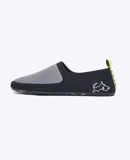 Lightweight gray and black slip-on shoe with mesh upper, zero-drop sole, and green heel tab.