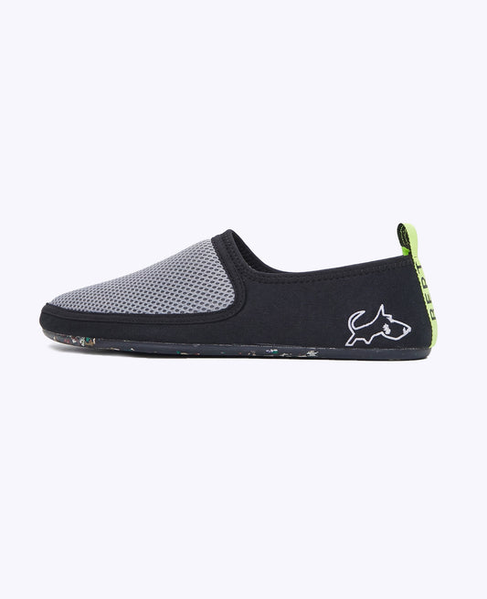 Lightweight gray and black slip-on shoe with mesh upper, zero-drop sole, and green heel tab.